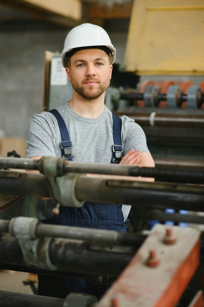 worker in factory on the machine